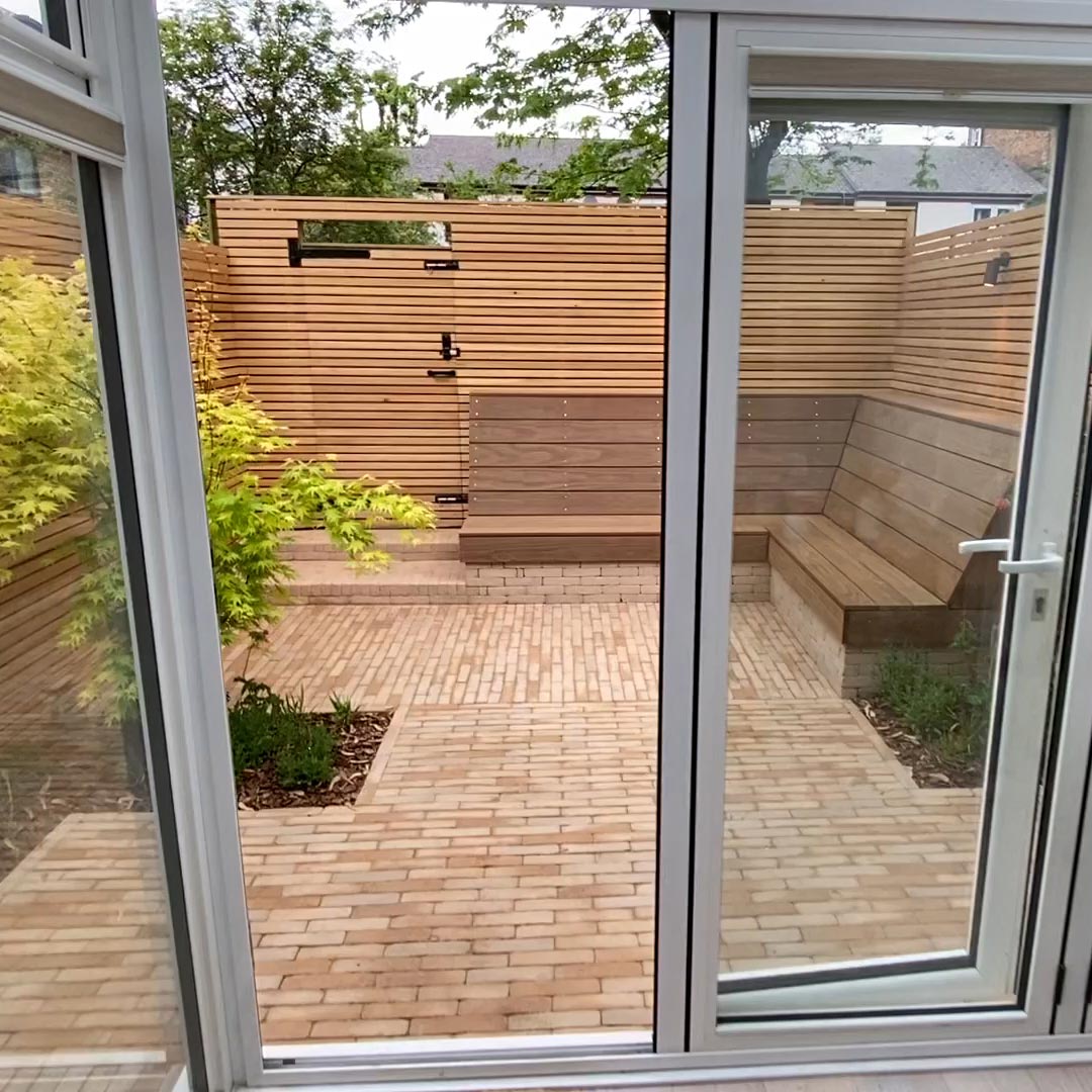 Looking out from the house showing the detailing of the new Larch clad back gate and fencing.