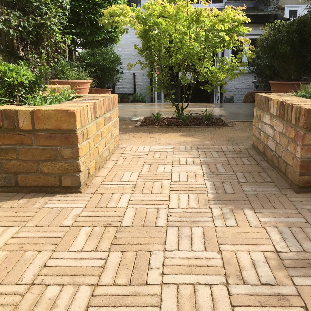 The chosen materials of this layout help to divide the garden; and the subtle changes in colour create a seamless transition from each defined zone.
