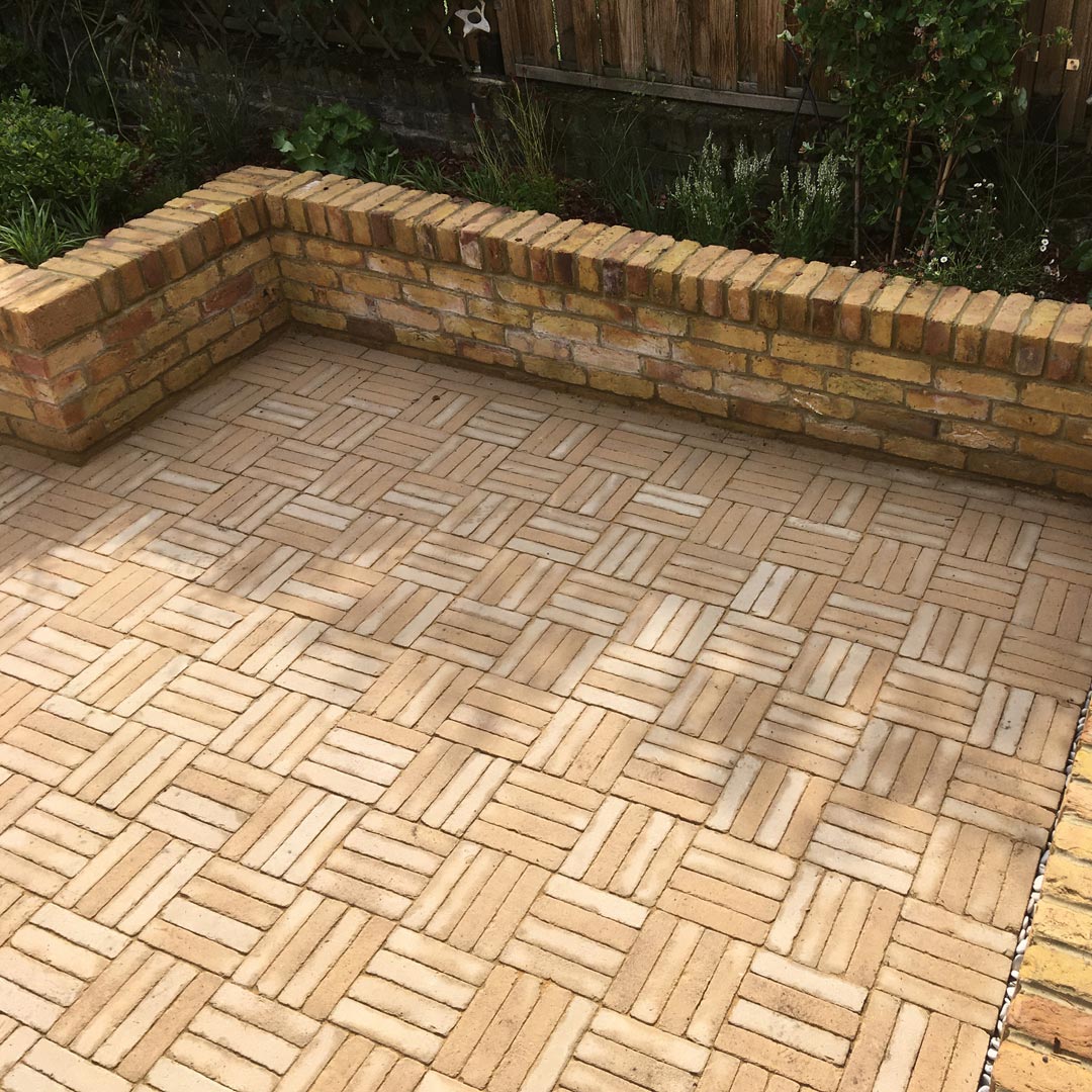 A close up of the basket-weave laying pattern of these Aureum Vande Moortel clay pavers, designed to define this area as the main entertaining space.