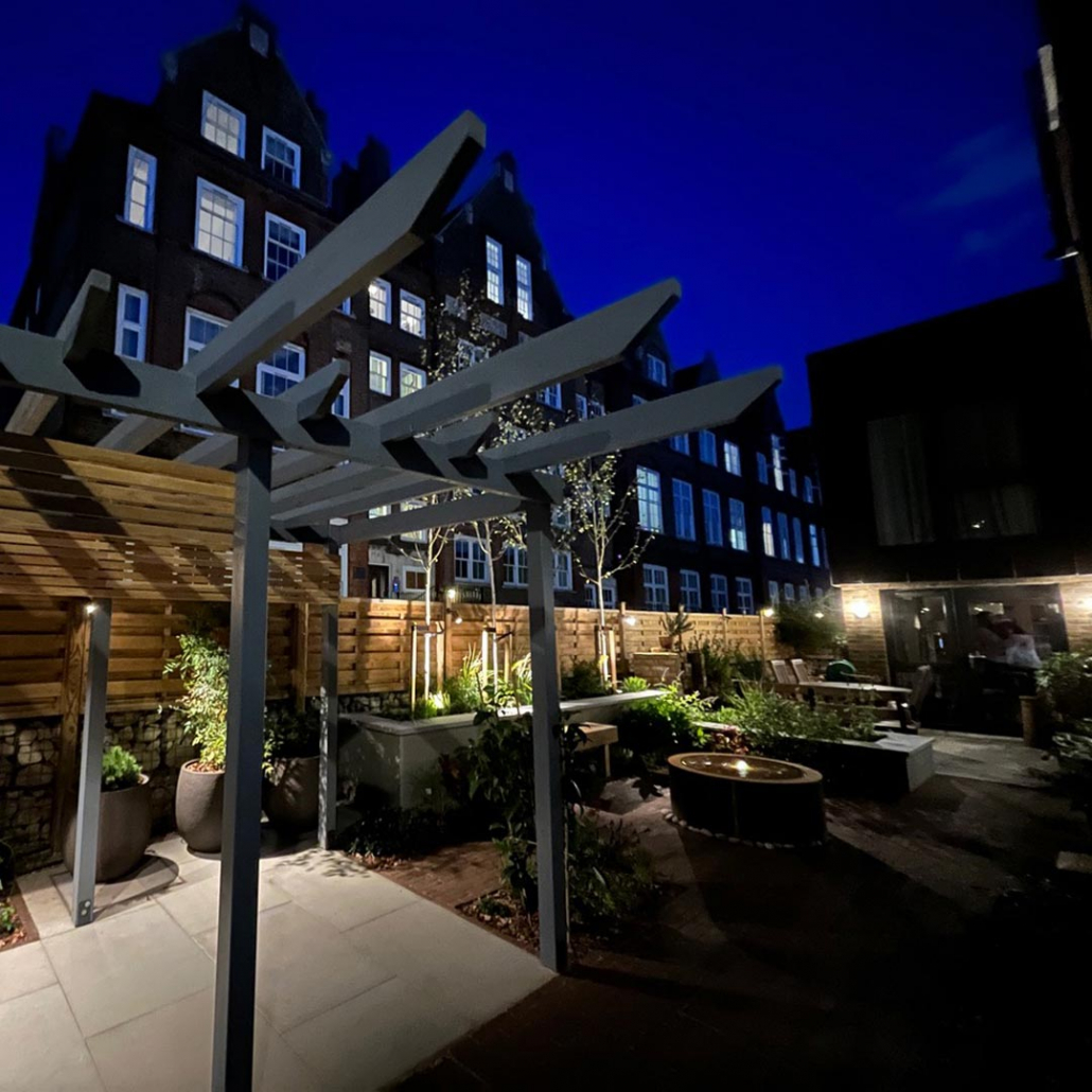 Outdoor lighting illuminates this unusual front garden in Highbury. A Japanese inspired pergola gives privacy from overlooking flats.