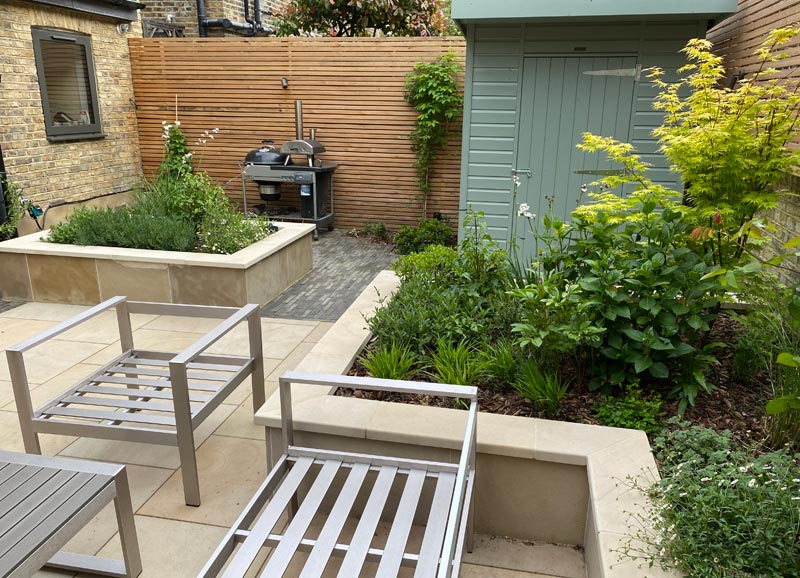 Various zones are divided by raised beds, softened with stunning Mediterranean planting and also feature larch screening & outdoor lighting.