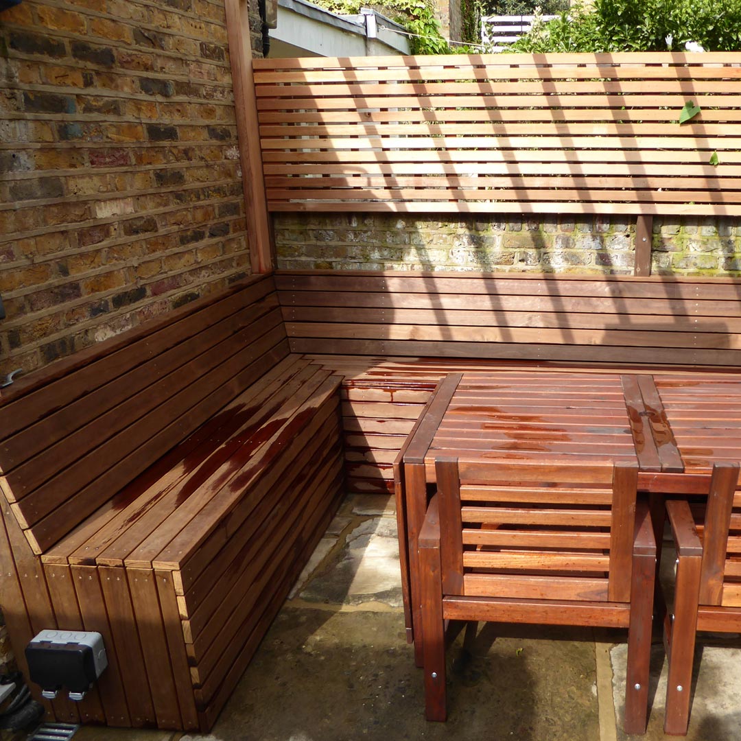 Bespoke Kebony benches and cedar-slatted screening.