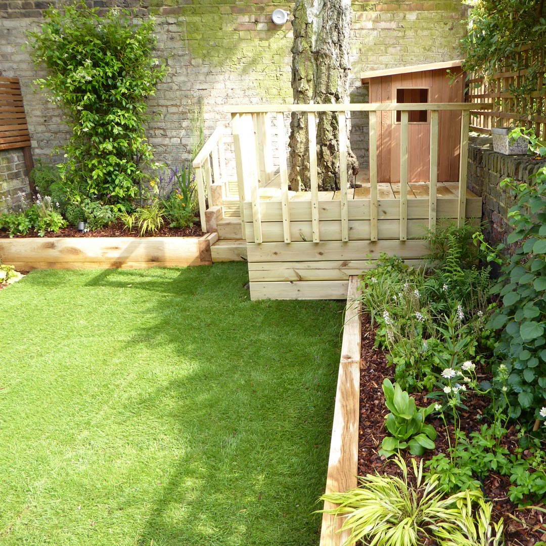 Mixed herbaceous planting; shrubs, climbers and grasses, designed for a shady spot.