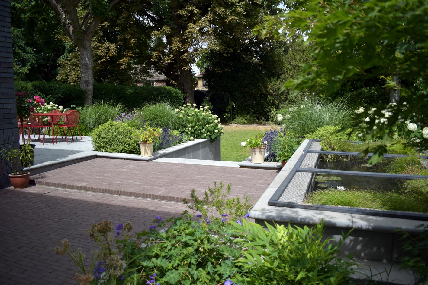 The angle of this photo shows the extent of the surrounding herbaceous perennials surrounding the fish pond.