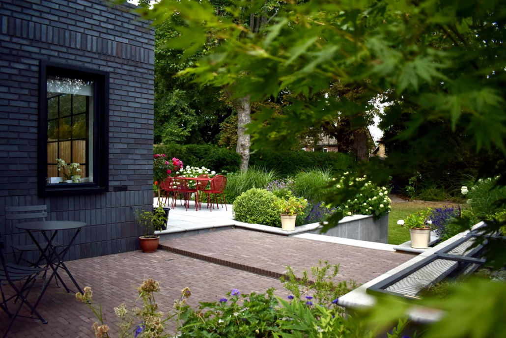 A view across the terrace that shows how the design layout tackled the many levels changes on this site. The material choices compliment the modern architecture of this new extension.