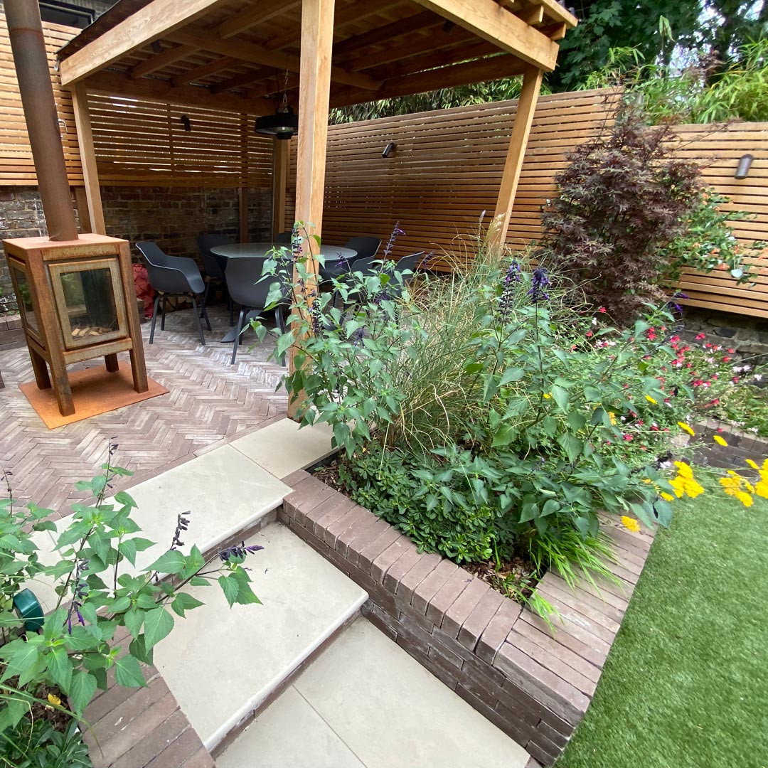 Focal planting of Salvia ‘Amistad’, Miscanthus, Veronicastrum, Achillea, Erigeron and Hakonechloa create a feast for the eyes.