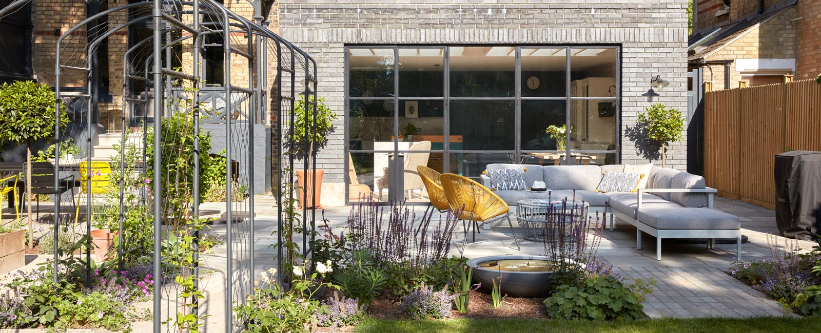 The large rear garden complements the architecture and is divided into zones. Features include a large area to entertain in, various focal points, pleached hedging for privacy, and a rose walk.