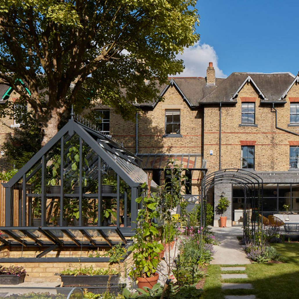 The garden design not only compliments the contemporary extension but links the garden to the Victorian architecture with its traditional glass house and rose walk.