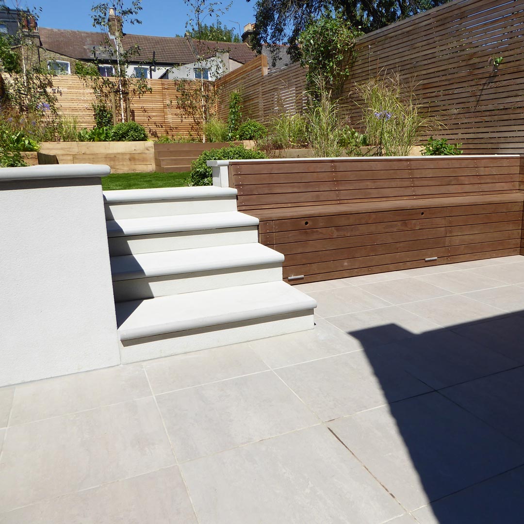 Detail of porcelain steps, patio, and Kebony bench with storage.