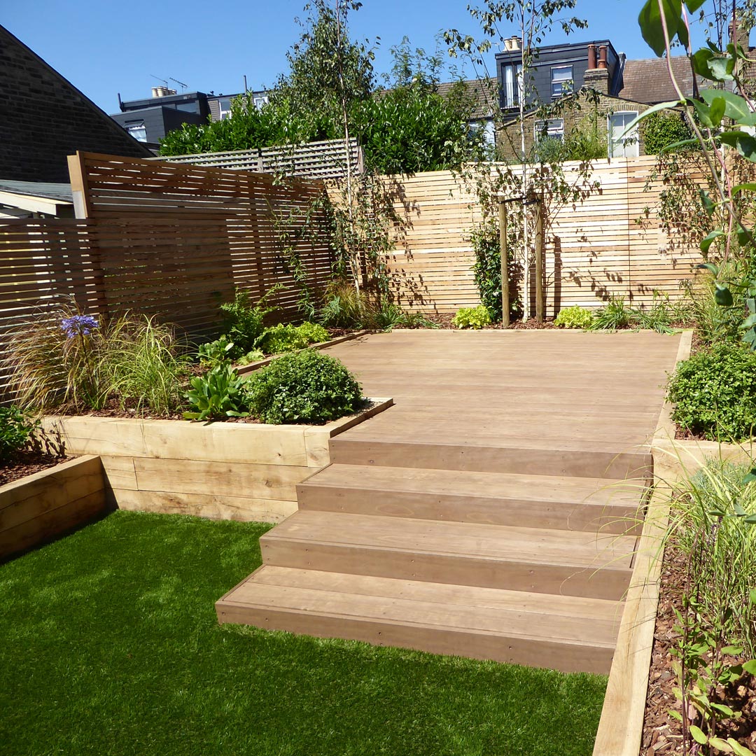 Steps compensate for the level changes between garden areas; and Larch screening creates privacy around the boundary.