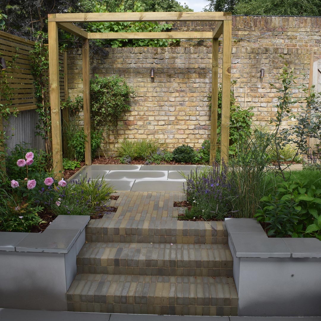 The clay brick pavers relate to the colours in the original Victorian garden wall.