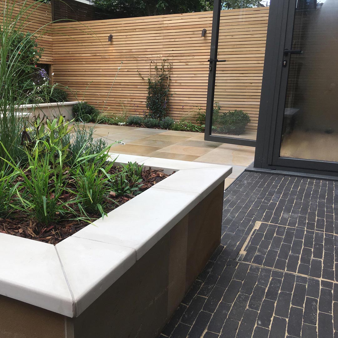 The grey tones of the clay paver path relates back to the colour of the new extension.
