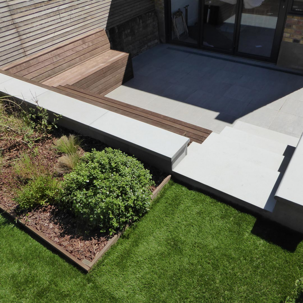 A garden with 3 level changes. Porcelain tiles, steps and Kebony benches with integral storage make up the main area directly from the house and kitchen.