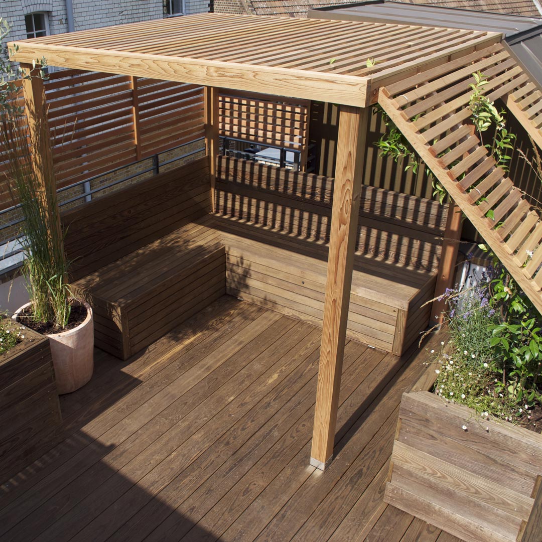 A bespoke pergola on a Bloomsbury rooftop. Made with Cedar slats that shade against a hot mid-day sun.