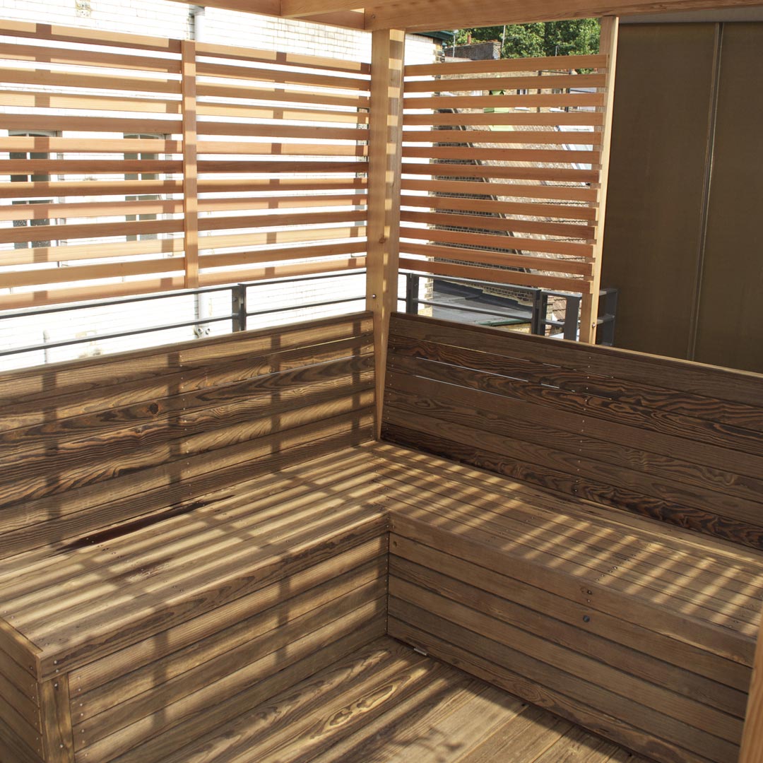 A detail of the Kebony benches with built-in cupboards.