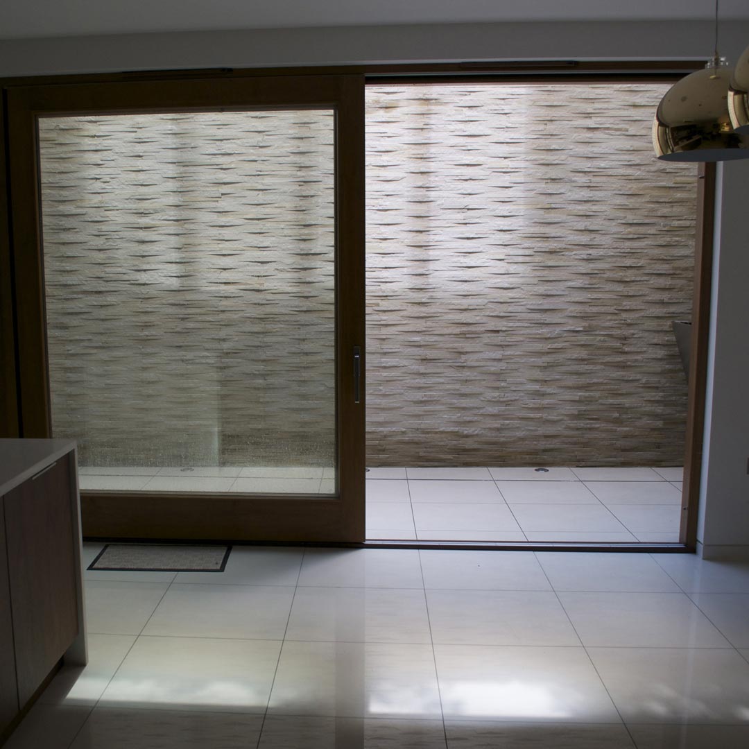 View from the modern kitchen onto the quartz stone clad wall.