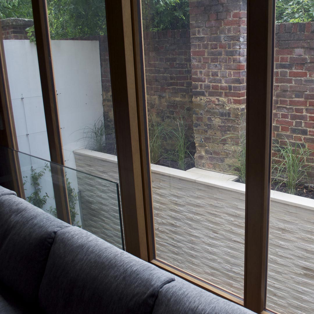 Top of the clad wall mass planted with grasses.