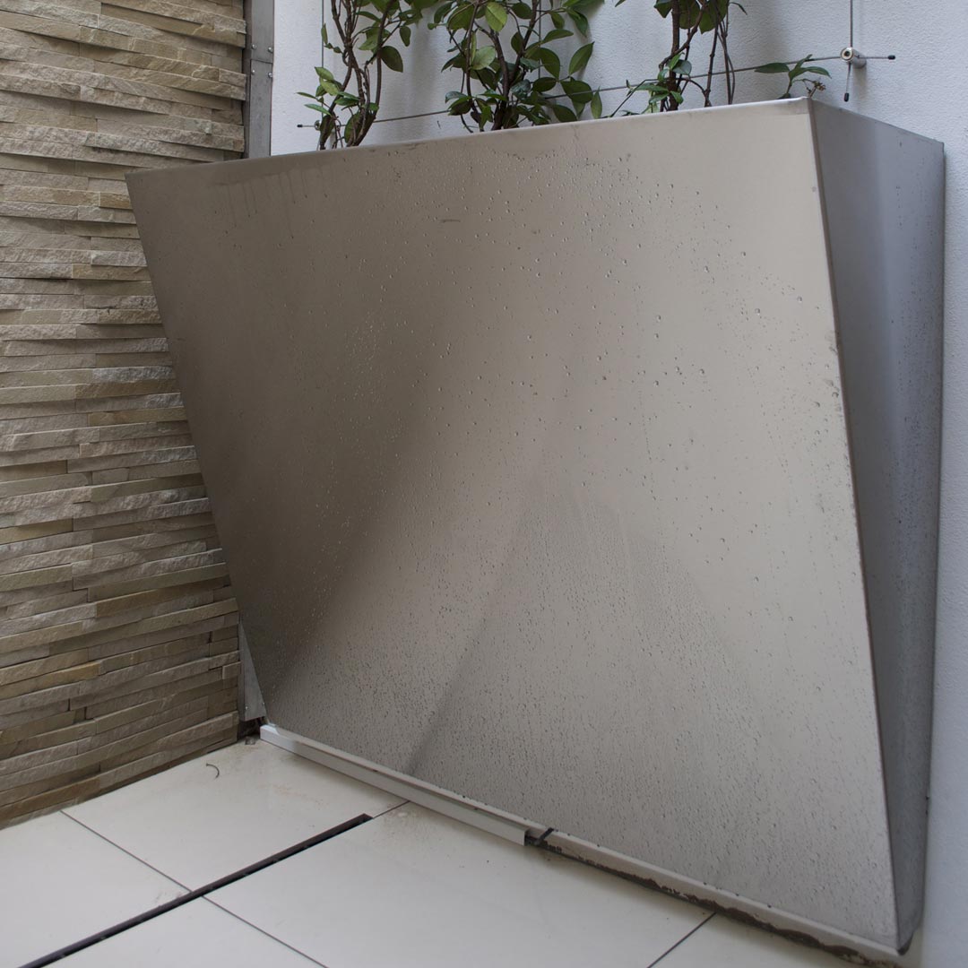 A fabricated stainless steel wall-pocket especially made for this space.