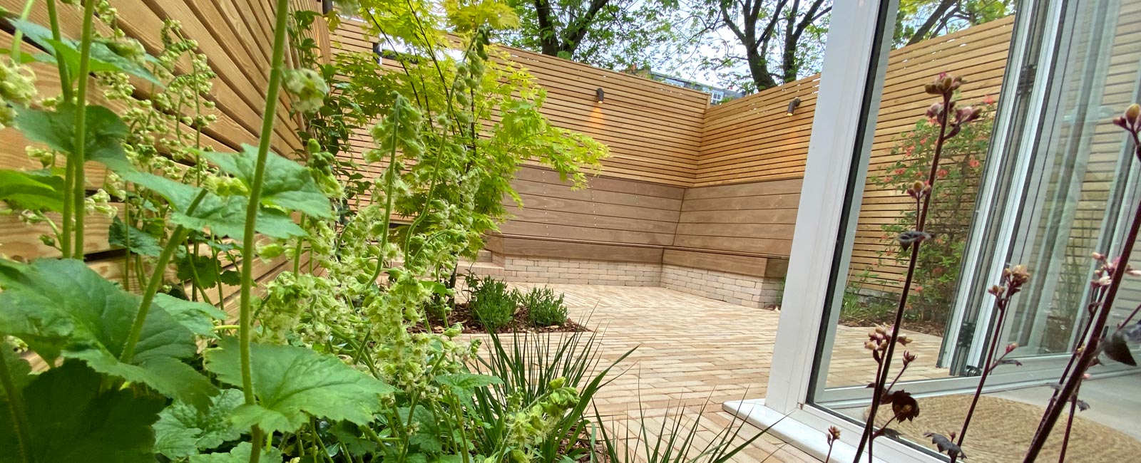 The planting scheme is attractive yet minimalist, requires little maintenance, and contrasts beautifully with the high-quality materials and Scandinavian influences.