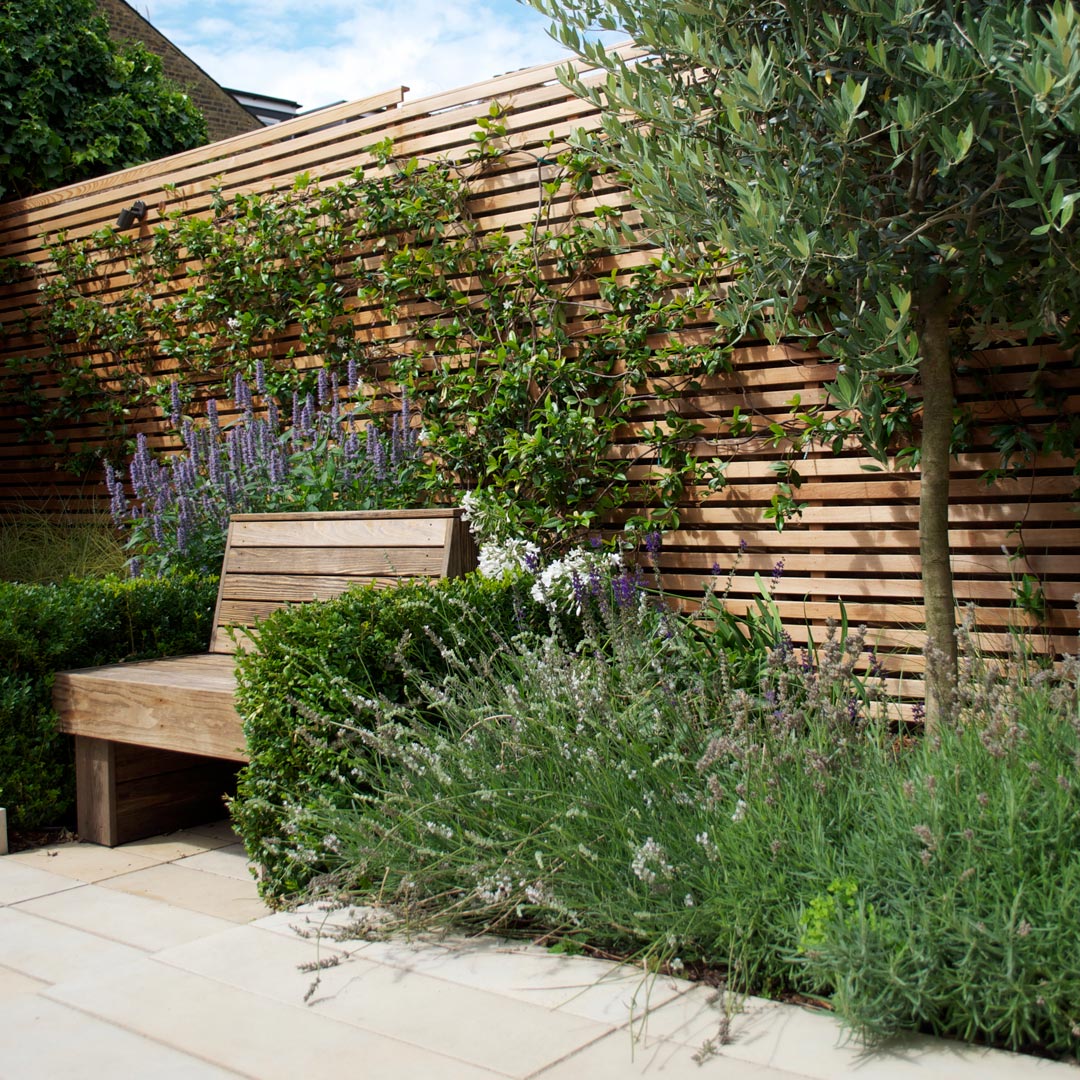 A made-to-measure bench surrounded by sun-loving planting.