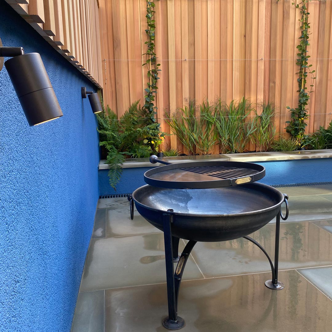 Hunza adjustable wall lights illuminate the upper terrace at night.